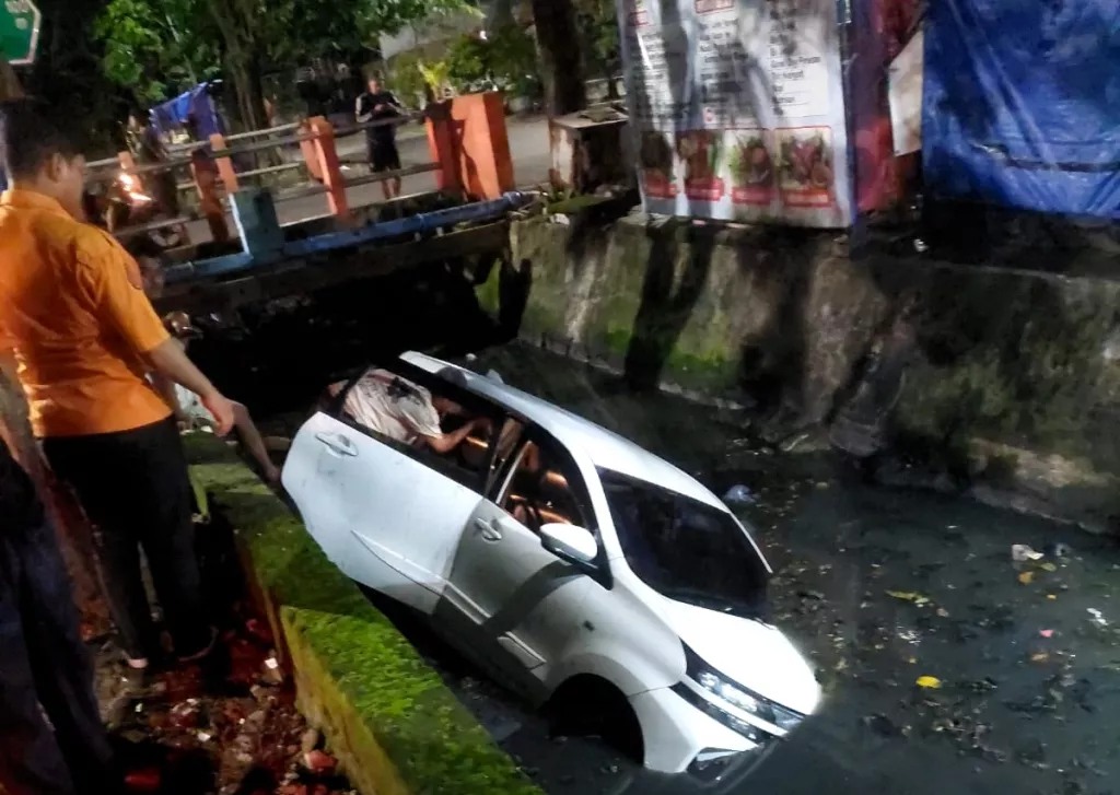 Mobil Avanza Putih Tercebur Sungai di Menanggal Surabaya